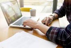 man typing on laptop